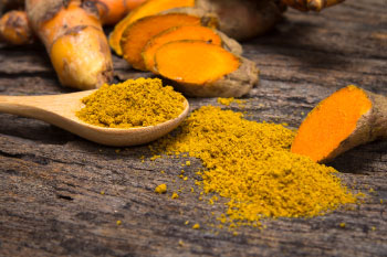 turmeric on wood table kitchen painkillers