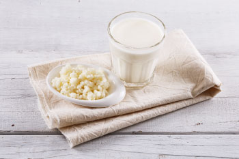 foods flu season glass of kefir on grey table