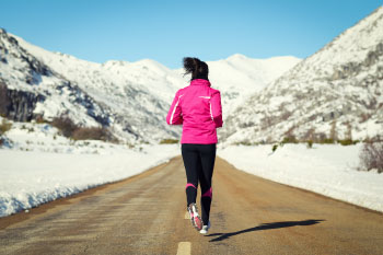 woman running in winter mountains reasons gain weight winter