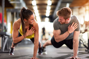 man and woman doing push up in gym men lose weight faster women