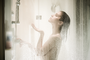 Woman having a hot shower sleep after late workout