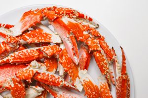 bowl of crab legs on white table