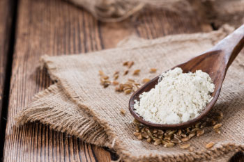 sprouted flour on a wooden spoon