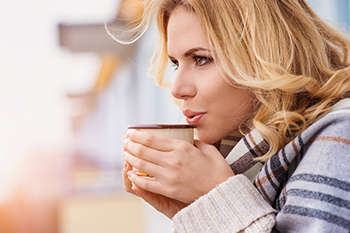 girl smiling holding hot chocolate raw cacao boosts health