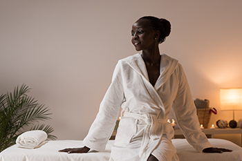 black woman wearing comfortable robe home spa