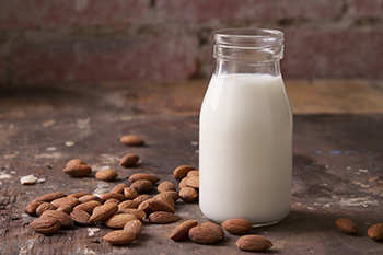 natural vertigo remedy almond seeds bottle of milk on table