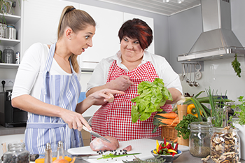 mother daughter making salad kitchen avoid weight loss mistakes