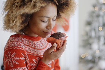 african woman eating chocolate cupcake avoid weight loss mistakes