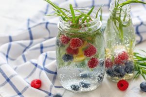 sparkling water with fruit on white towel