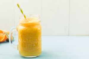 orange smoothie on blue table