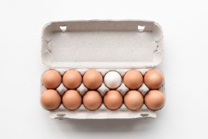 carton of eggs on white table